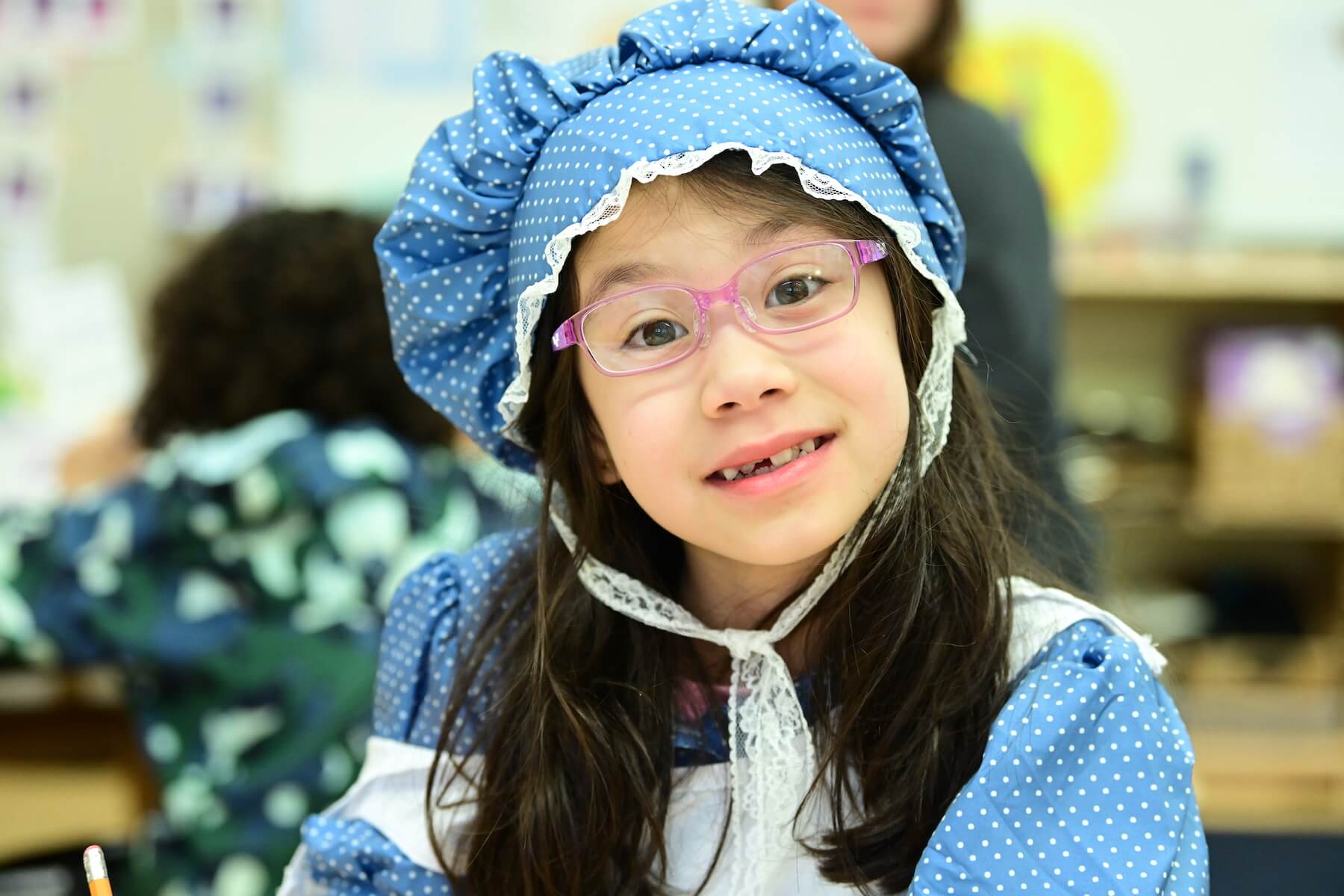 Ethical Culture Fieldston School Ethical Culture student smiles in a period costume with a bonnet