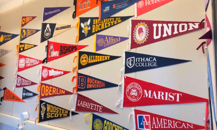 College flags on the wall of the Ethical Culture Fieldston School College Counseling Office