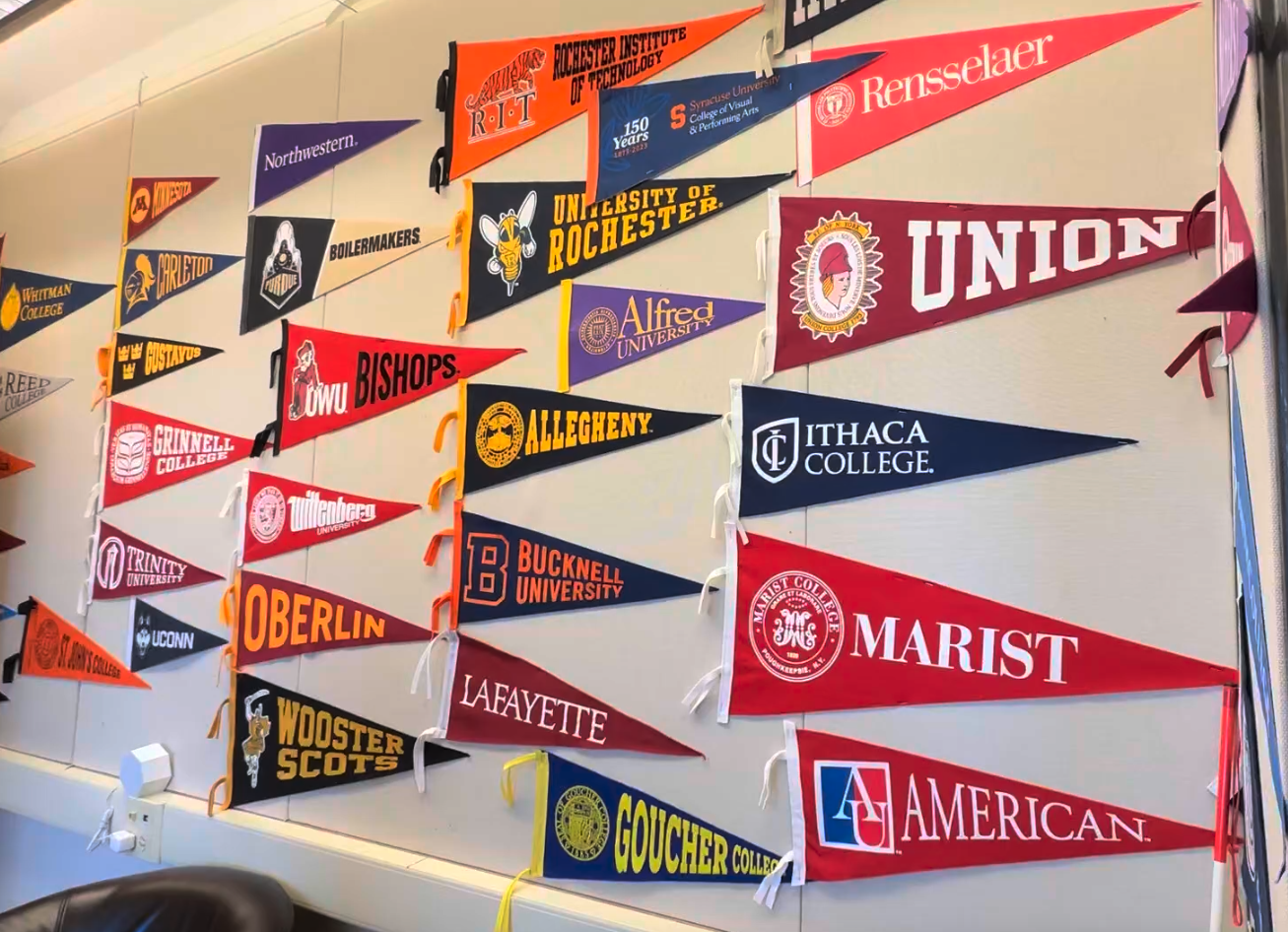 College flags on the wall of the Ethical Culture Fieldston School College Counseling Office