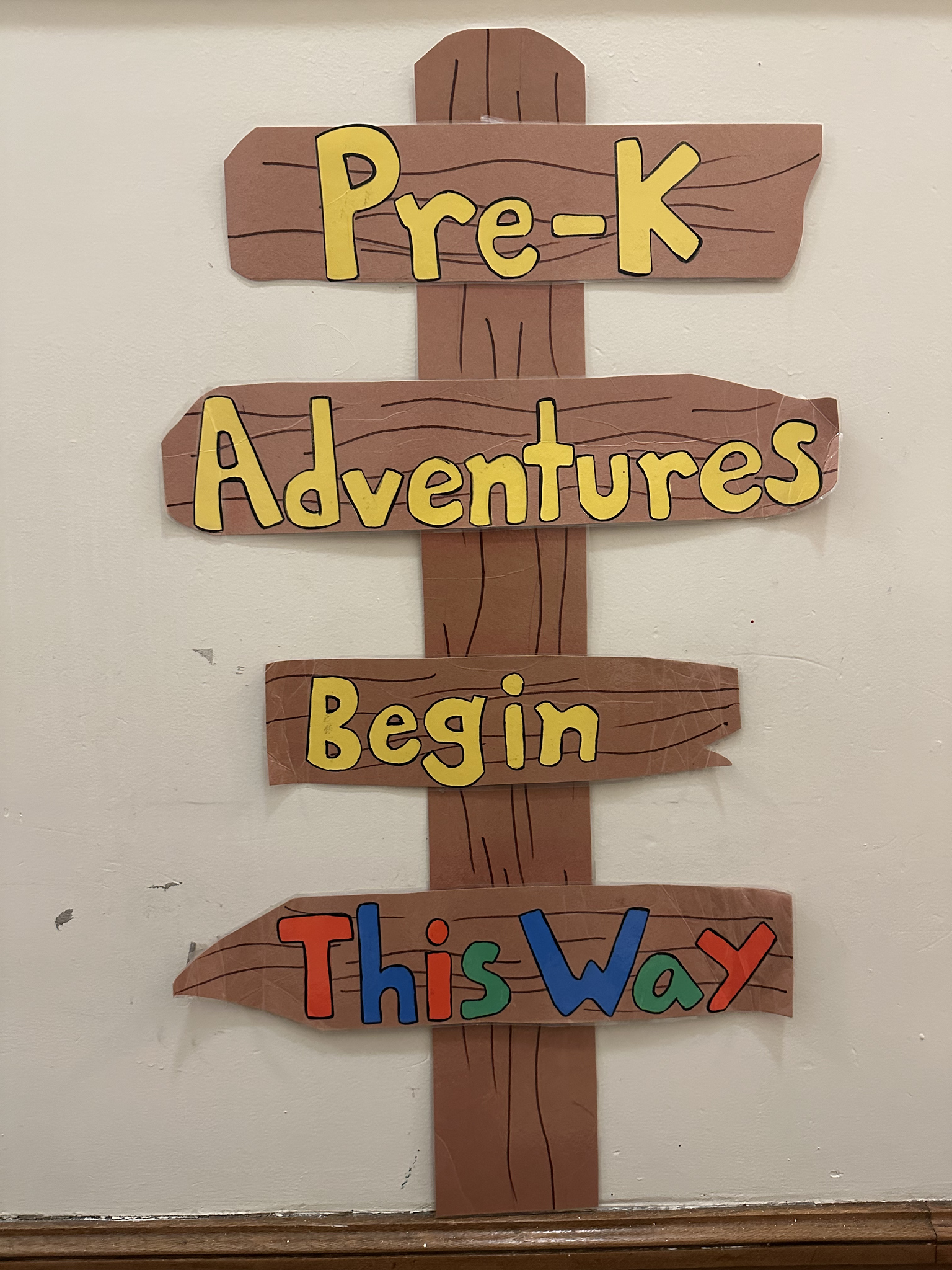 Sign poster outside of Ethical Culture Pre-K classroom that reads, "Pre-K Adventures Begin This Way."