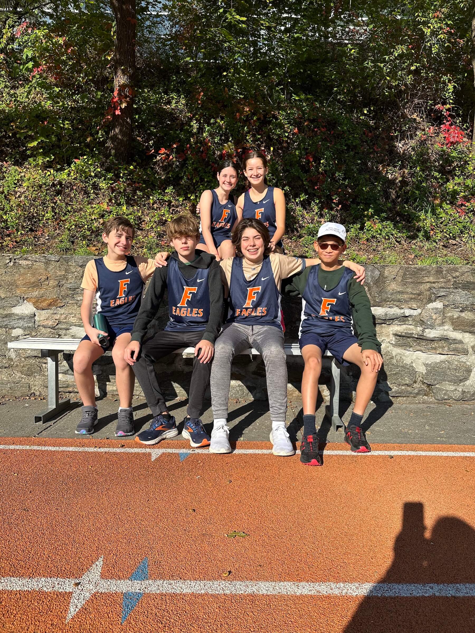 Ethical Culture Fieldston School_Feel Good Photos_Middle School track team sits on bench for team photo