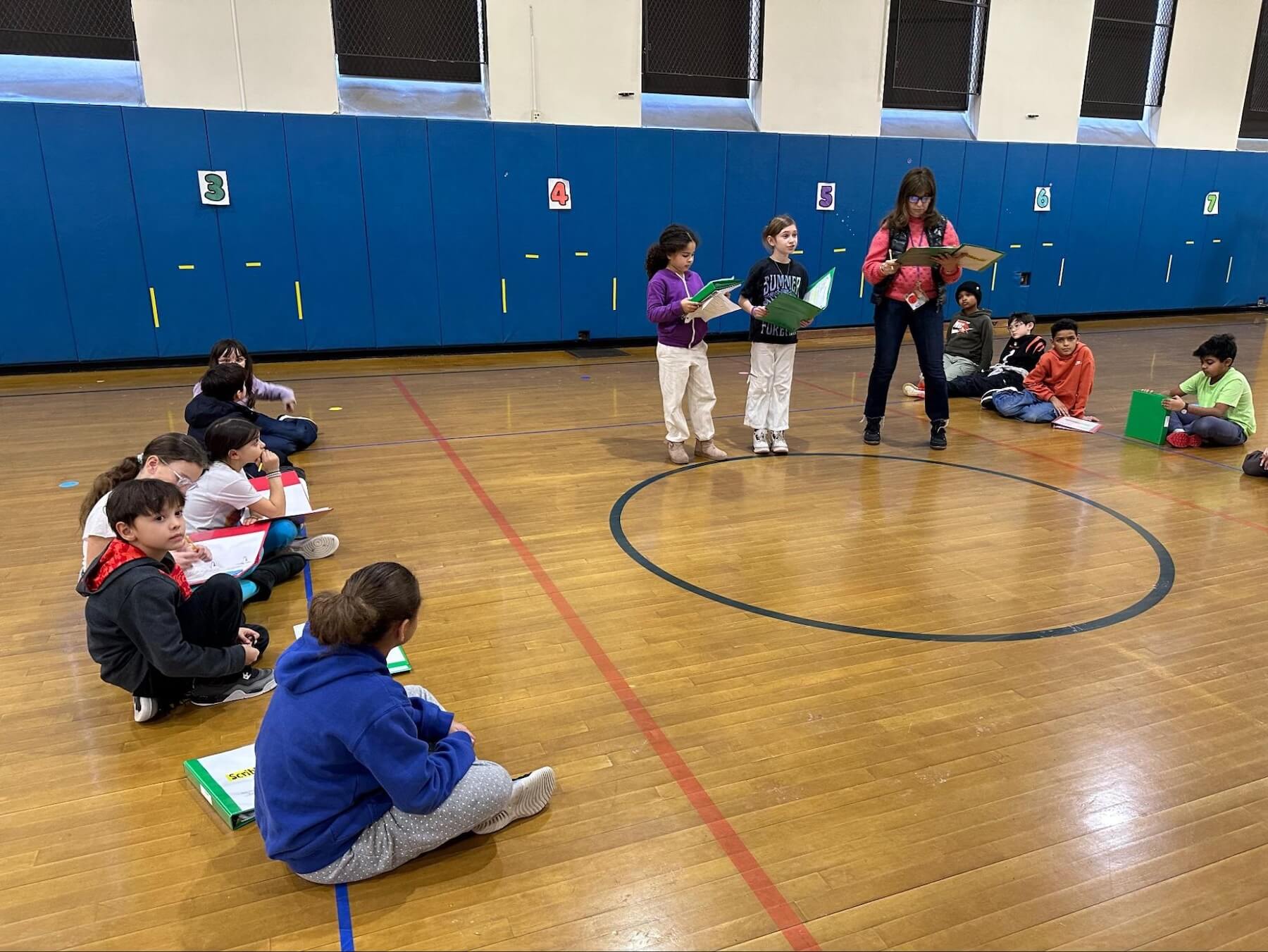 A group of Ethical Culture Fieldston school students rehearses for the 3rd Grade musical in the gym.