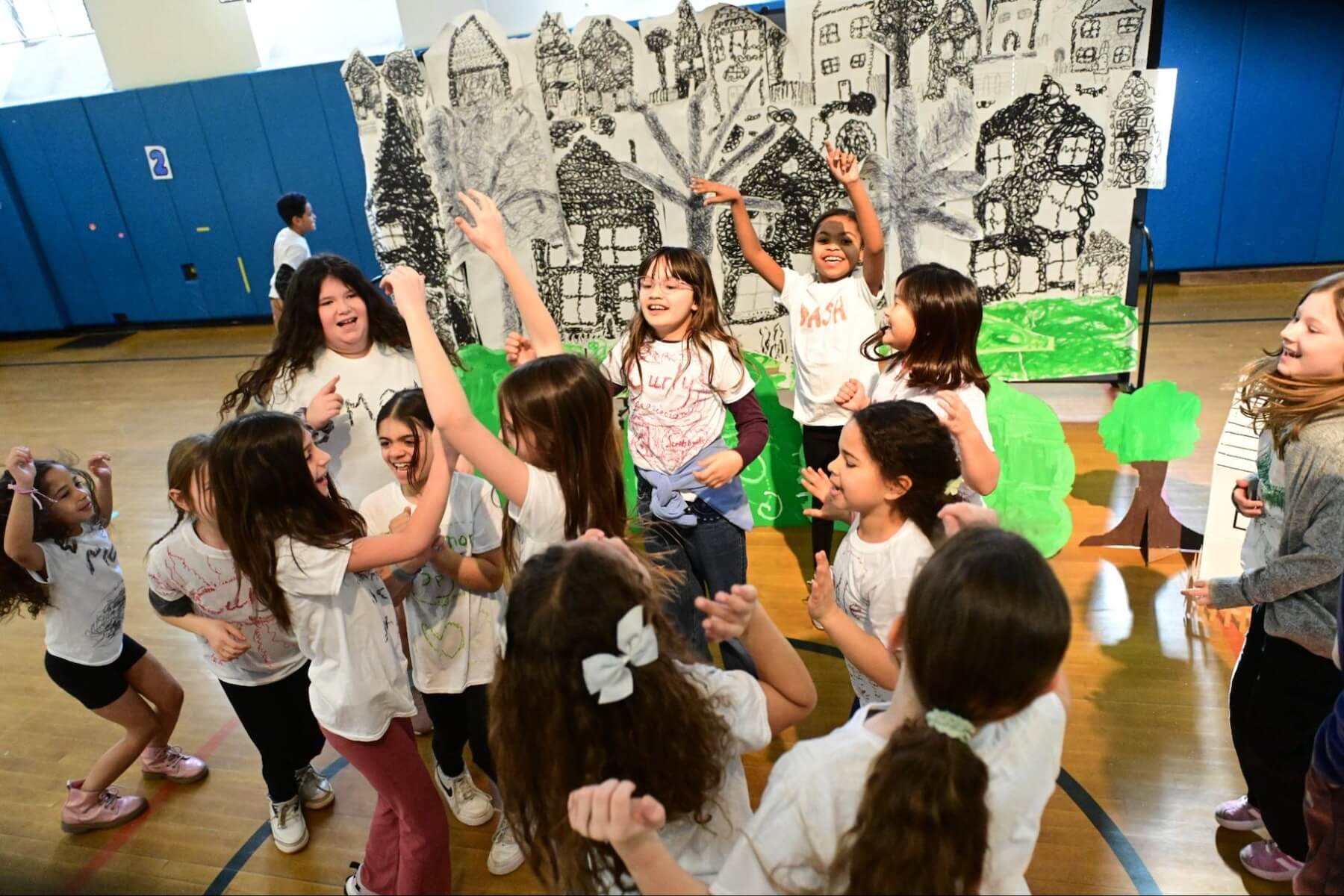 Fieldston Lower 3rd Graders celebrate the end of their performance with a dance party.