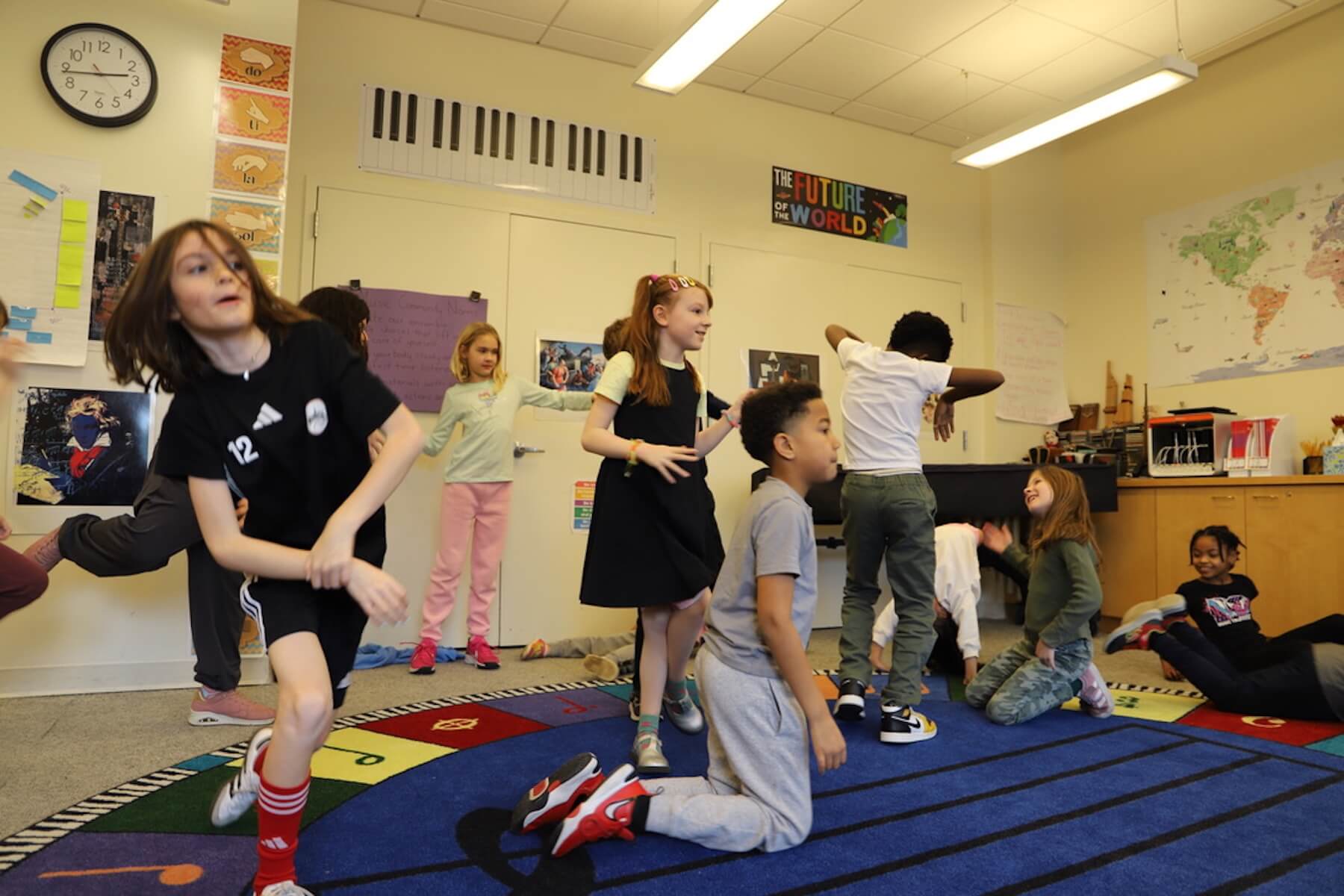 A group of Fieldston Lower 3rd Graders dance around the music room, practicing their choreography for the musical joyfully.