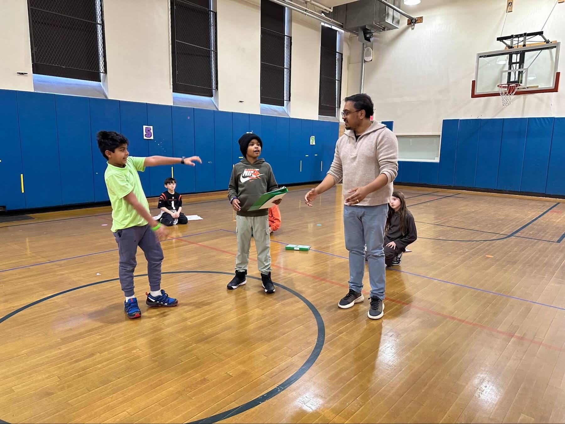 An Ethical Culture Fieldston School teacher guides a group of students during a rehearsal for the 3rd Grade musical.