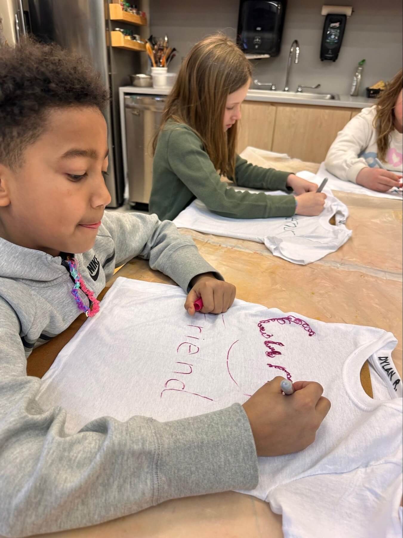 A Fieldston Lower 3rd Grader designs the costume he will wear while performing in the musical.