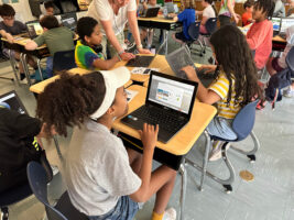 Fieldston Lower student works on designing her Google Earth tour on her laptop.