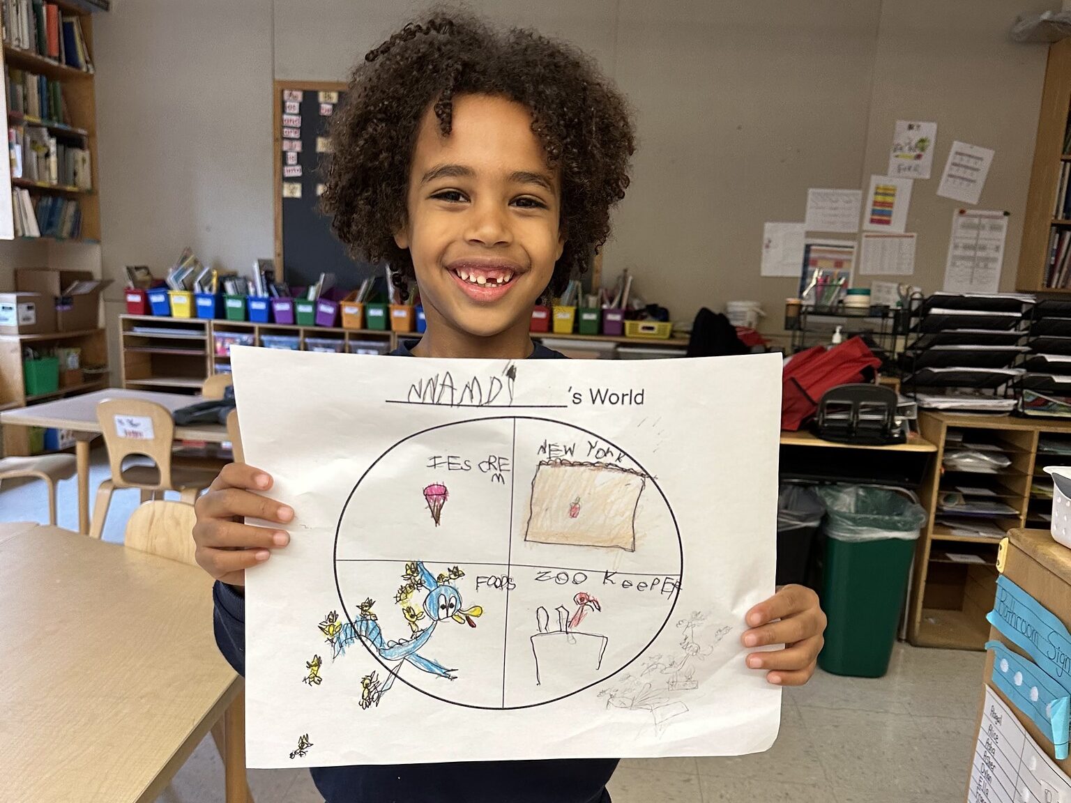 Fieldston Lower student poses with "My World" project.