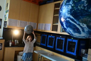 Fieldston Lower student tries out eclipse model at Homecoming.