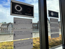 Informational flyers about the moon phases hagning on the wall outside of Wilkinson's classroom.