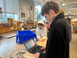 Three Ethical Culture Fieldston School students work on a project.