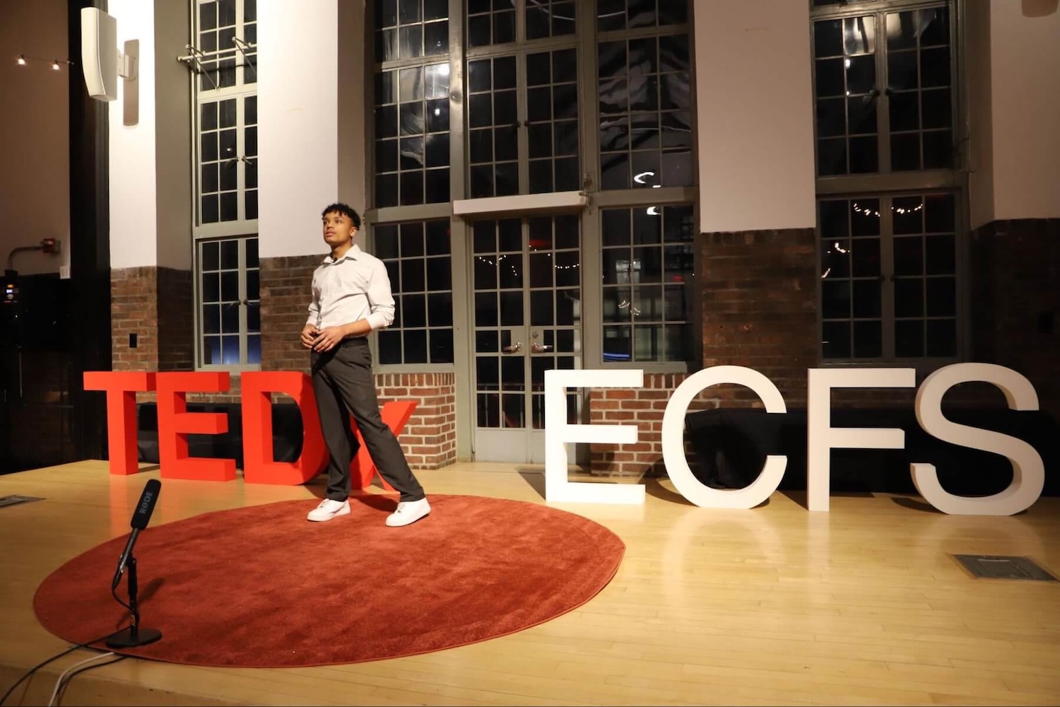 A student at the Ethical Culture Fieldston School presents animatedly at the TEDxECFS event.